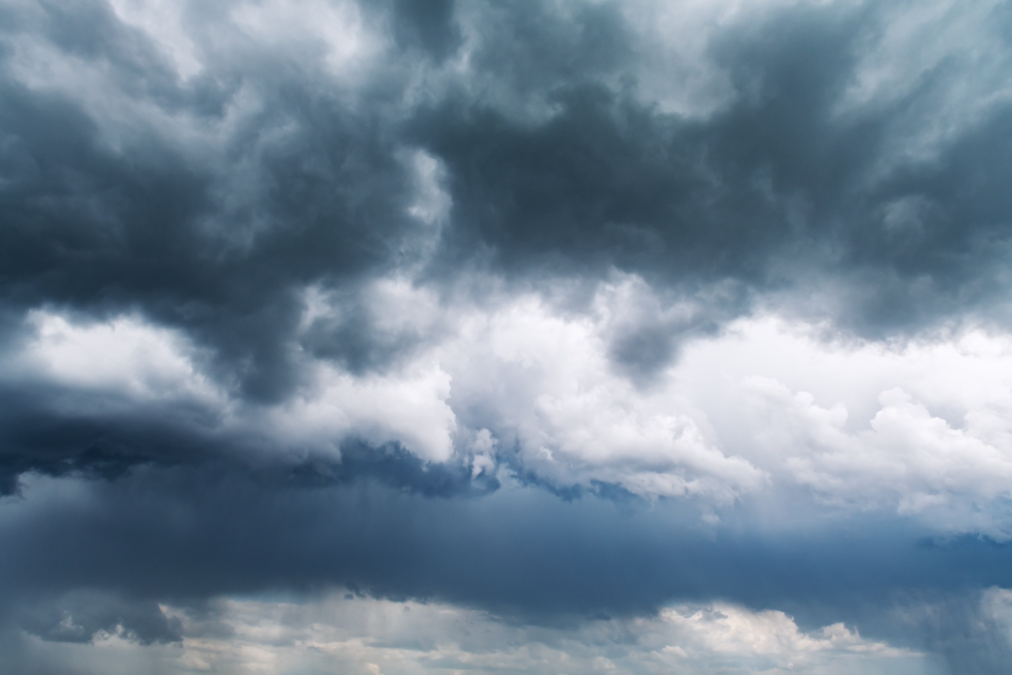 Ominous dark storm clouds gathering overhead in the sky